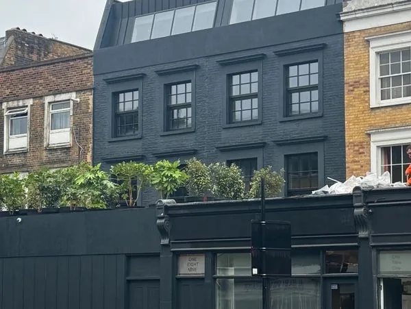 Completed London residential building — mansard roof extension with rooftop planting